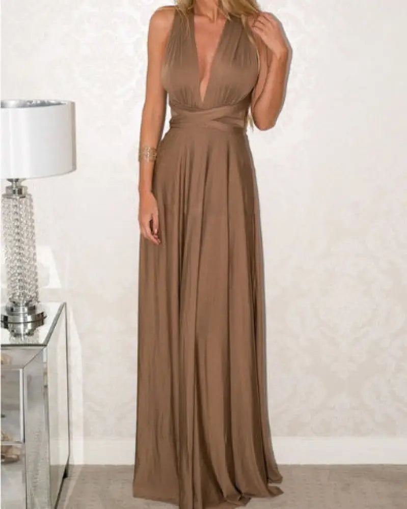 A flowing taupe satin multiway halter neck maxi party dress shown from the back with a deep v-back and gathered waistline