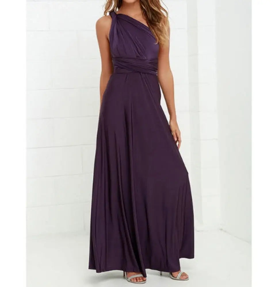 A flowing deep purple satin multiway halter neck maxi party dress with a draped bodice and pleated skirt