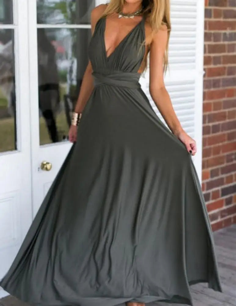 A flowing olive green satin multiway halter neck maxi party dress shown from the back with a deep v back and gathered waistband
