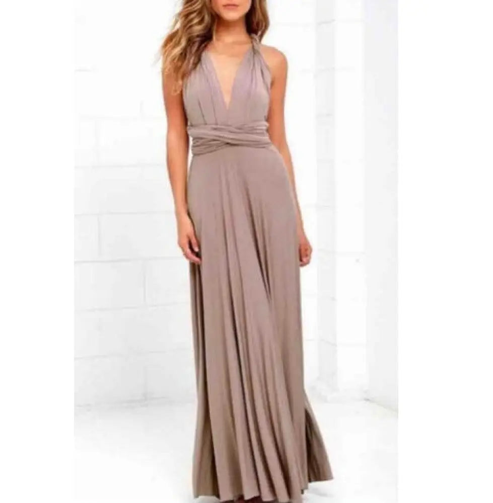 A flowing taupe satin multiway halter neck maxi party dress with deep v-cut and pleated skirt