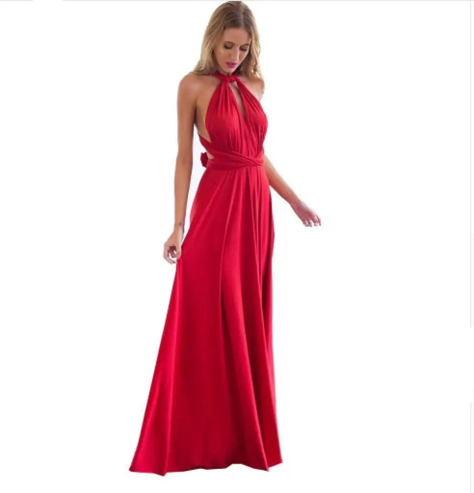 A flowing red satin multiway halter neck maxi party dress with a draped waistband and back cutout shown from the back