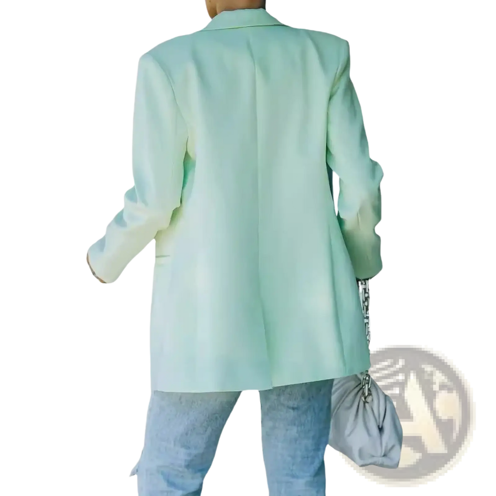 A soft mint green oversized women blazer with relaxed fit and long sleeves for casual office wear