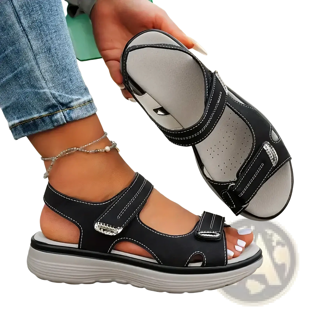 Women platform sandals in black leather look with silver buckle accents and thick cushioned sole for casual beach wear