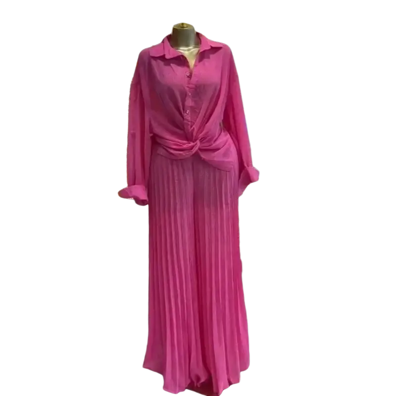 A vibrant fuchsia long-sleeved button-up shirt with knotted waist paired with matching pleated wide leg maxi pants