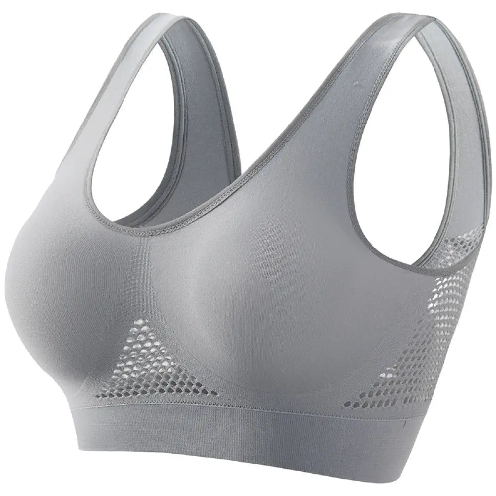 Gray seamless plus size moisture wicking sports bra with mesh side panels and supportive design for athletic use