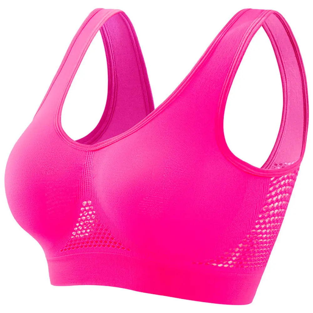 Bright pink seamless plus size sports bra with moisture wicking fabric and mesh panels on the sides