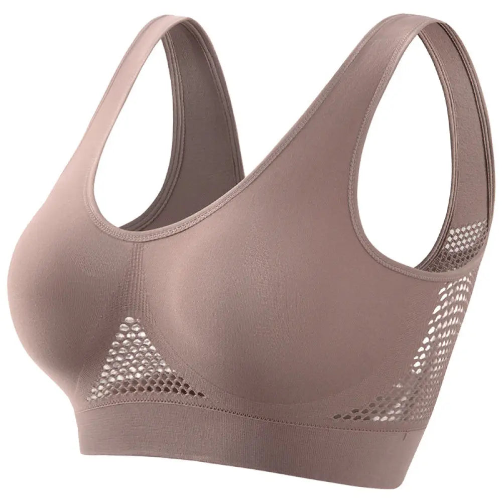 A taupe seamless plus size moisture wicking sports bra with mesh side panels and stretchy fabric design