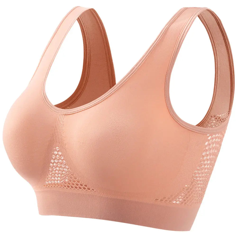 A blush pink seamless plus size sports bra with mesh side panels and moisture wicking stretchy fabric design