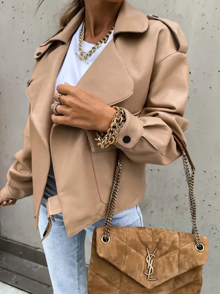 Tan quilted suede ysl handbag with gold-tone chain strap and logo clasp paired with relaxed beige faux leather jacket with pockets