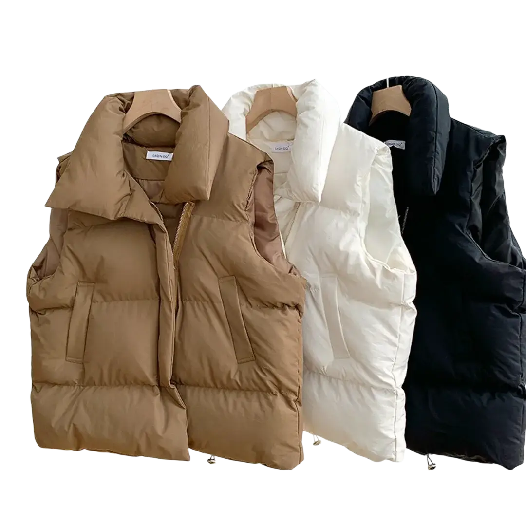 Three quilted puffer vests in camel white and black for women winter casual outerwear on a rack
