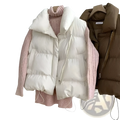 Women quilted puffer vest in cream color with high collar and front zipper worn over pink knit sweater