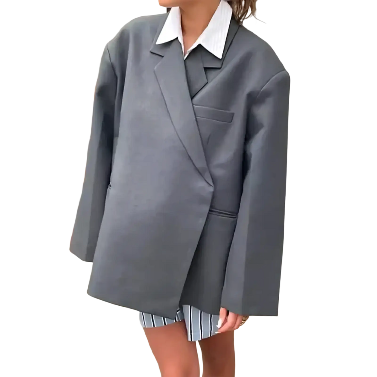 Woman wearing an oversized gray blazer and white collared shirt holding a red patent leather tote bag