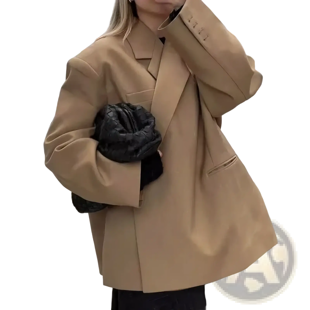 Women red patent leather tote bag shown with tan oversized blazer with structured shoulders and black quilted handbag