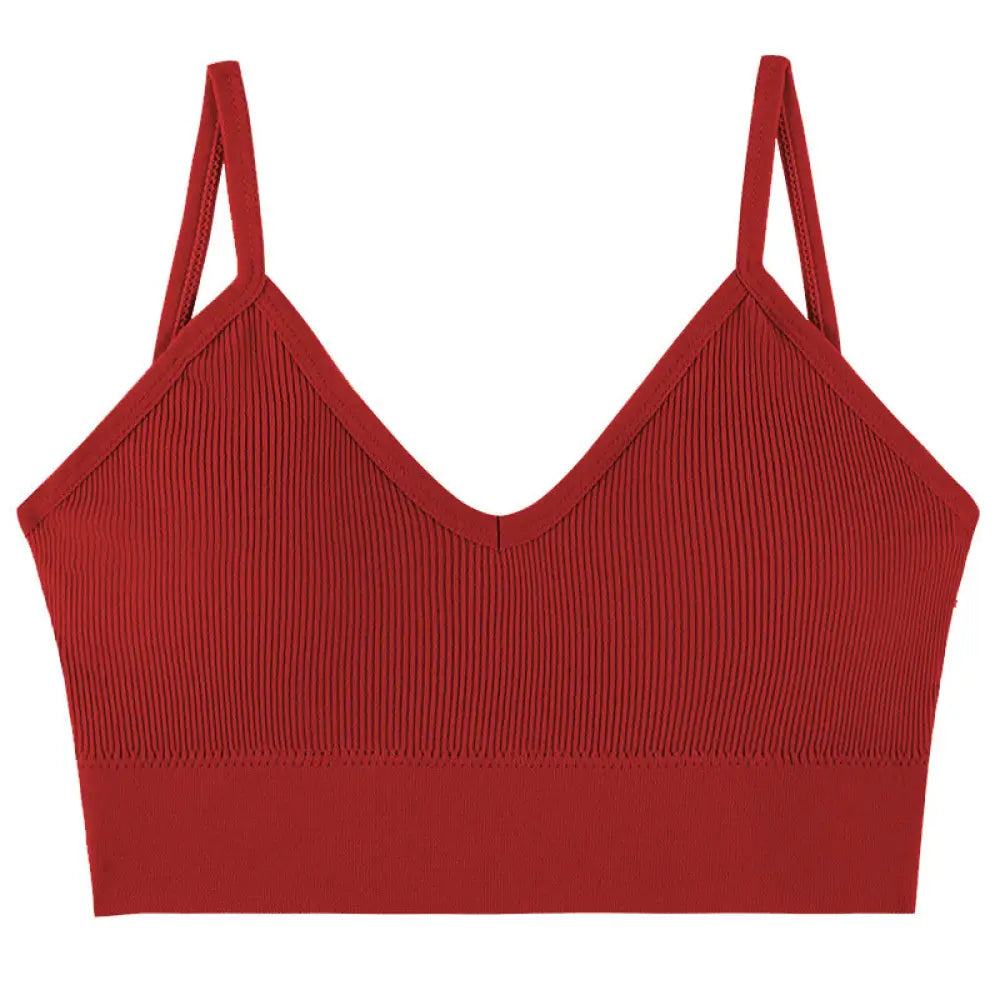 Seamless red ribbed knit sports bra with v-neckline and adjustable thin straps for comfortable support