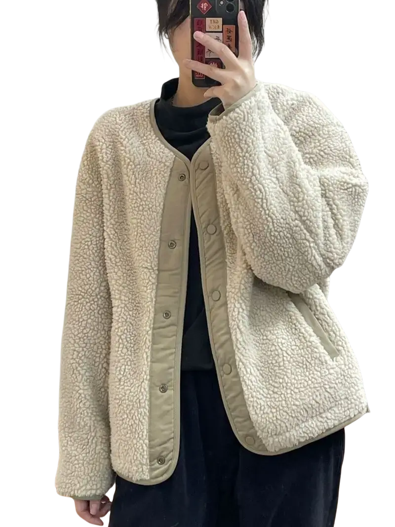 Women shearling bomber jacket in cream color with beige trim and button closures made of soft shearling material