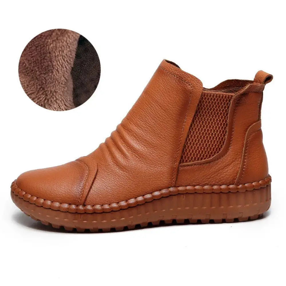 Women’s tan leather velvet lined winter chelsea boot with textured mesh panel and stitched sole shown from back