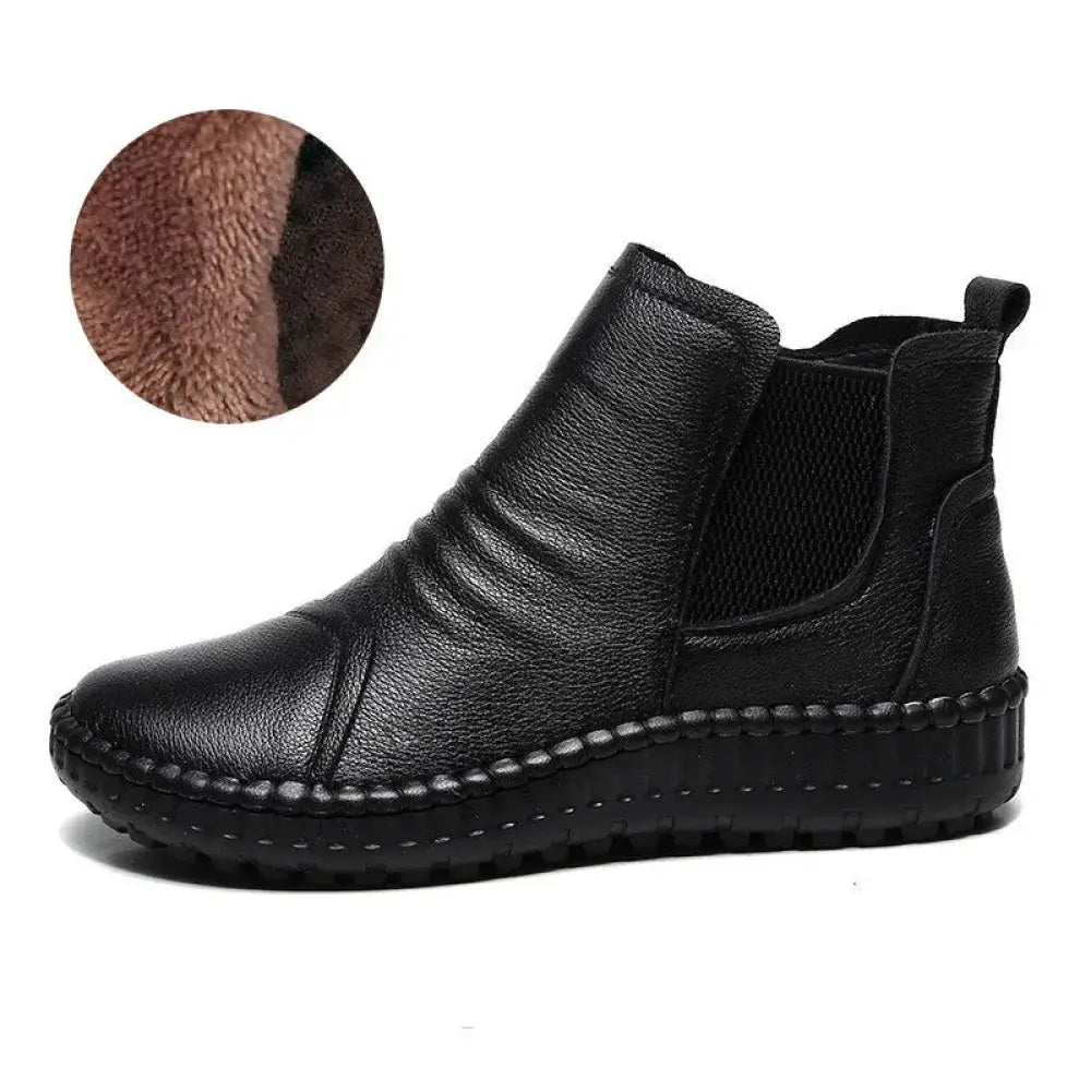 Black leather women’s chelsea boot with plush brown velvet lining and visible stitching along the sole for winter wear