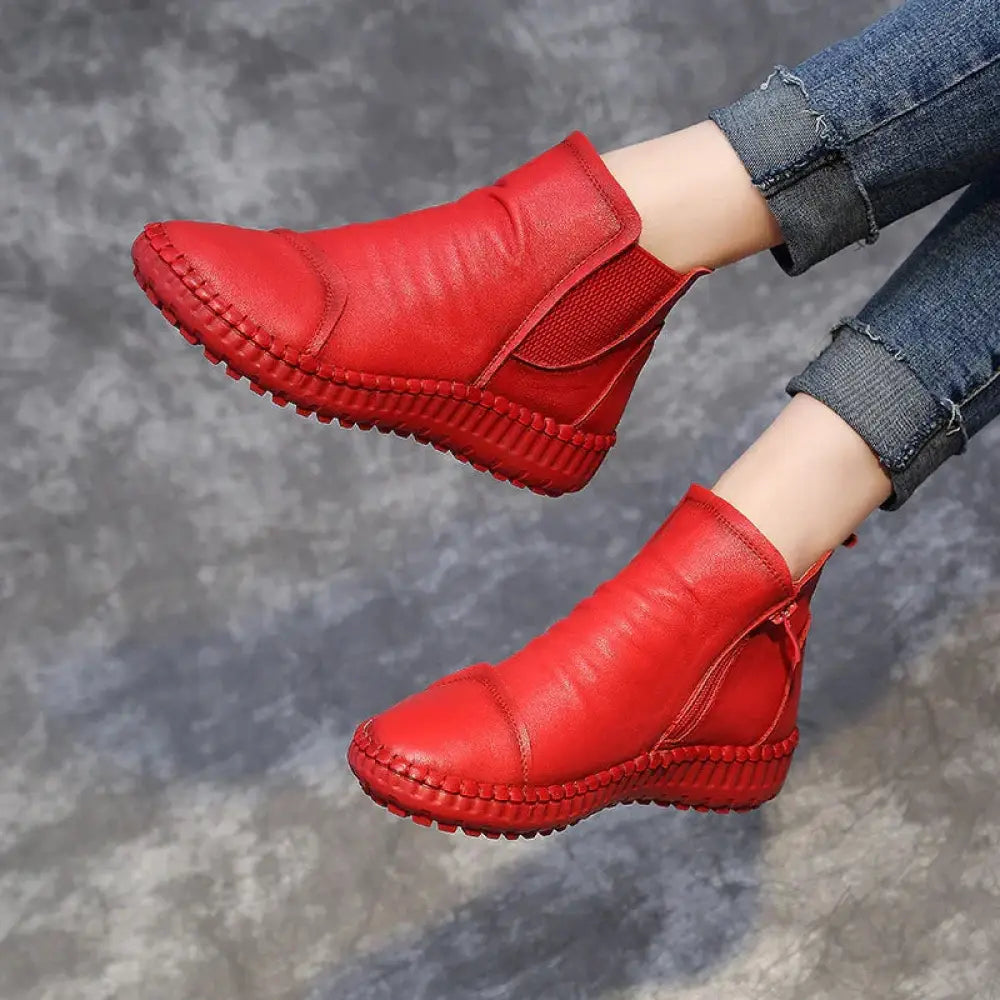 Women’s tan leather velvet lined winter Chelsea boots with vibrant red leather ankle design and braided sole
