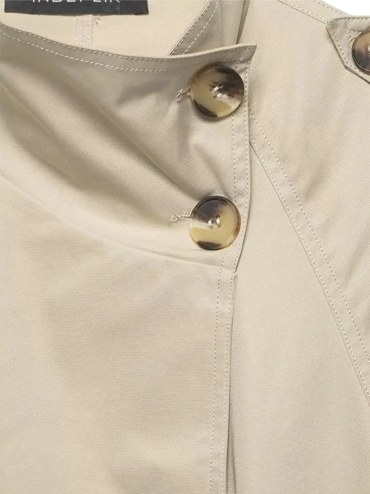 Women short beige trench coat featuring gold-toned buttons and neat stitching in a classic design
