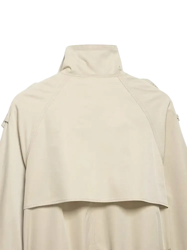 Women short beige trench coat with high collar and structured shoulders made from lightweight fabric