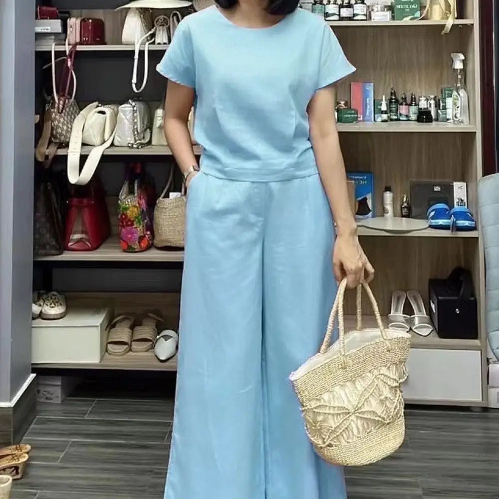 Light blue linen short sleeve two-piece set featuring a wide leg pant designed for comfortable stylish wear