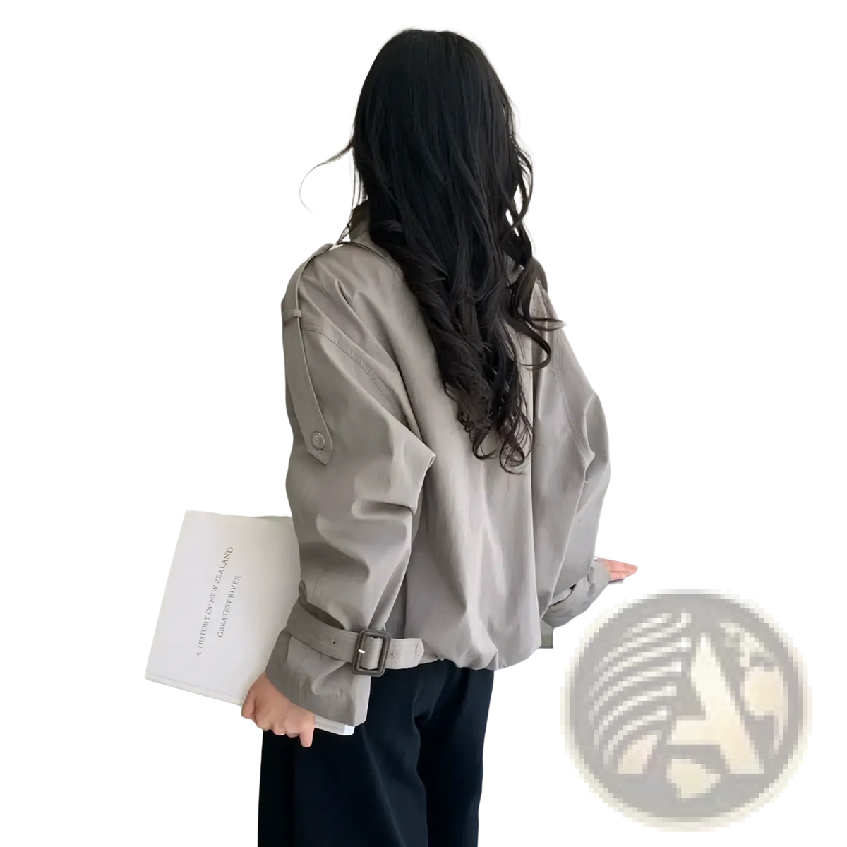 A woman wears a beige short double breasted trench coat with adjustable belt and buttoned cuffs in this outerwear