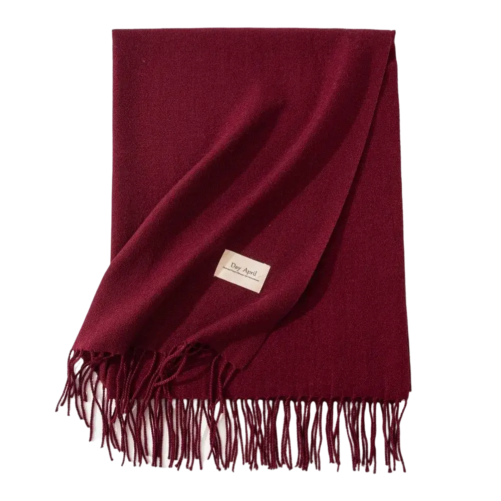 A rich burgundy solid cashmere winter scarf with delicate fringe and subtle woven texture for women