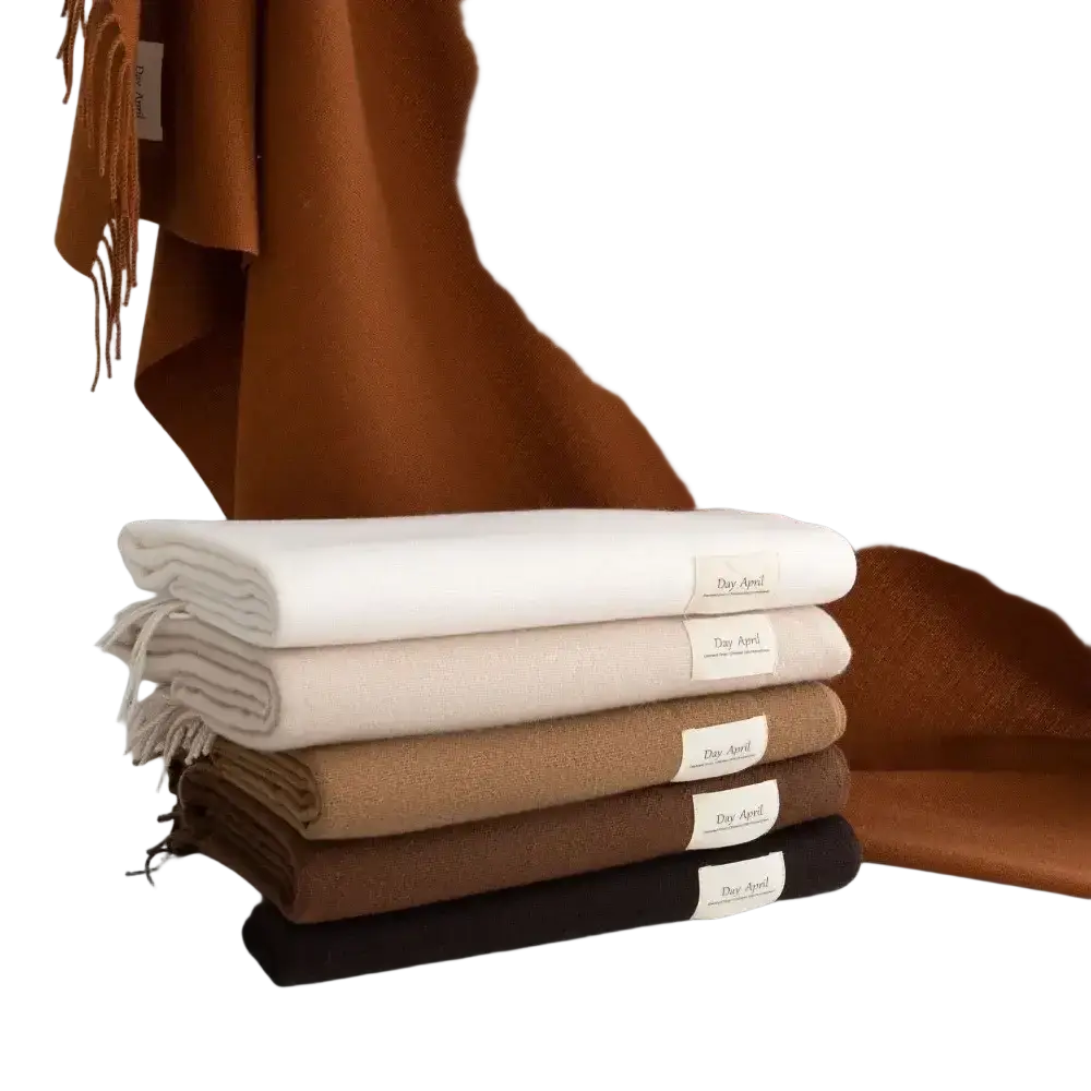 Stack of solid cashmere winter scarves in earthy tones labeled dear april for women solid cashmere winter use