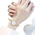 Women stainless steel quartz bangle watch in rose gold tone with white dial roman numerals and twisted rope bracelet design