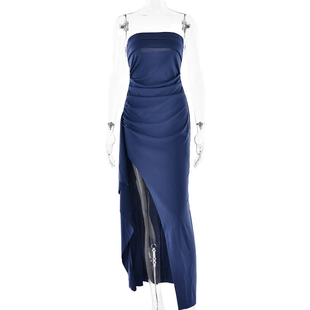 A sleek navy blue satin strapless pleated maxi gown with ruched bodice and high slit perfect for formal events
