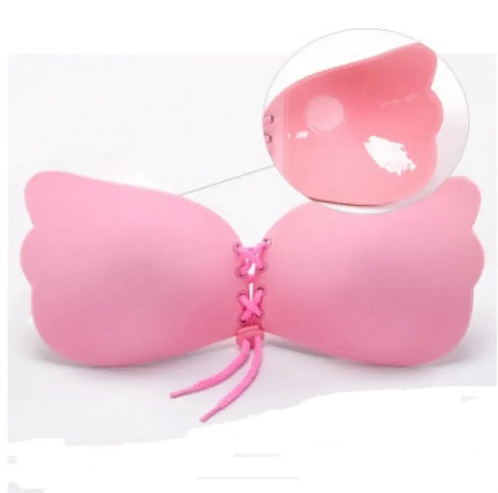Pink silicone adhesive strapless push up bra with lace-up front and bow-shaped design for enhanced support