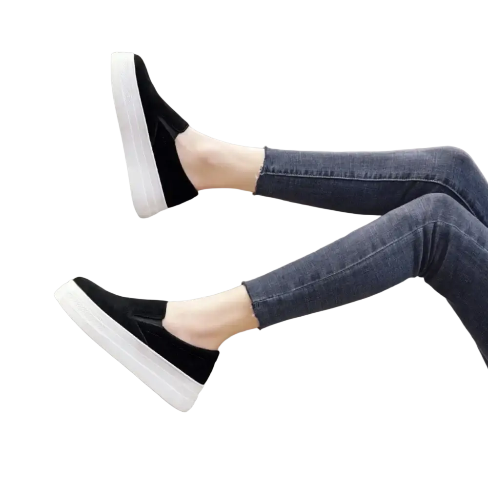Black suede women slip-on platform sneakers with thick white sole for casual wear shown from the back side