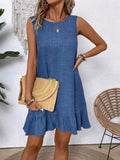 Blue sleeveless denim dress with ruffled hem and subtle texture designed for summer vacation beach wear