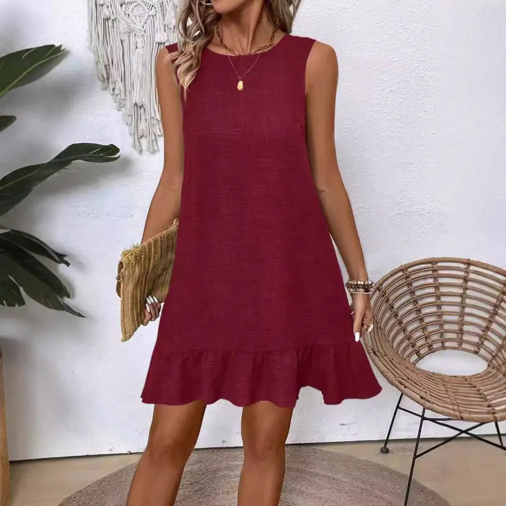 Sleeveless maroon a-line summer vacation beach dress with ruffled hem and subtle textured fabric