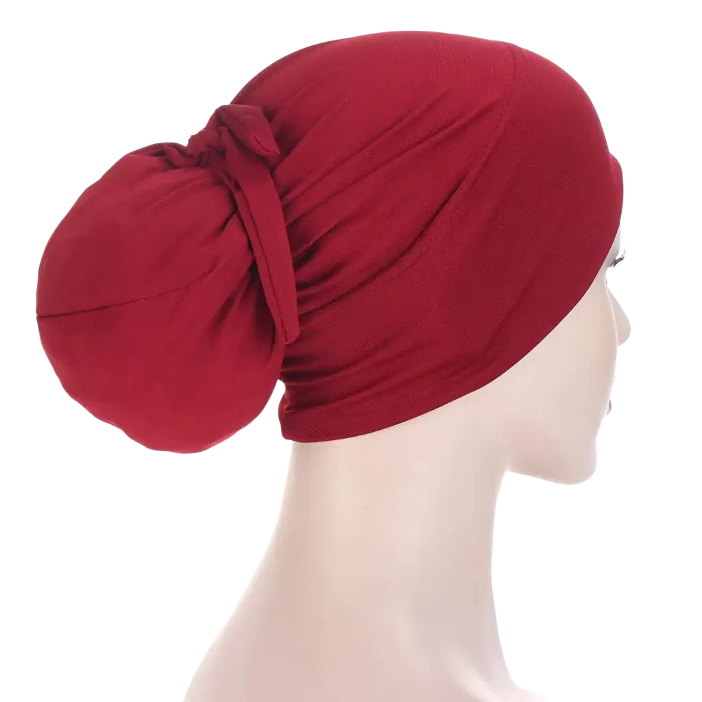 Women tie-wrap hijab cap in soft deep red stretchy fabric shown from the back with a gathered knot wrap style