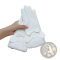 Women touch screen winter fleece gloves in white leather with fluffy trim and decorative bows at the wrist showing back side