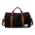 Black canvas women’s gym and weekend travel duffel bag with brown leather straps and handles