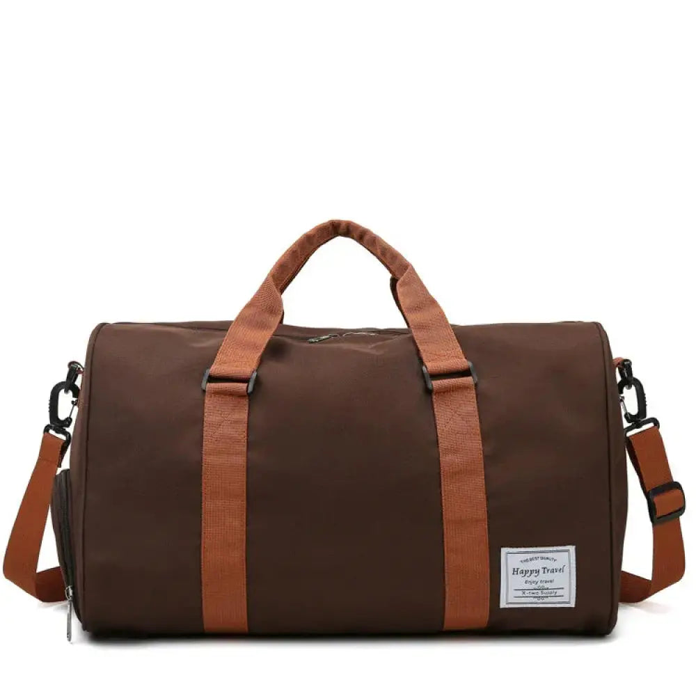Brown canvas gym and weekend travel duffel bag with tan leather straps and a white happy travel label