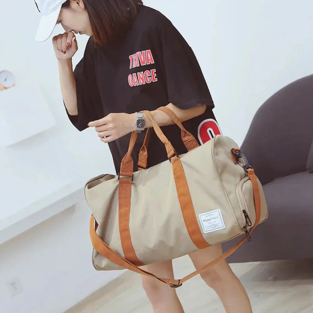 Beige and tan women’s canvas gym and weekend travel duffel bag with sturdy handles and detachable shoulder strap