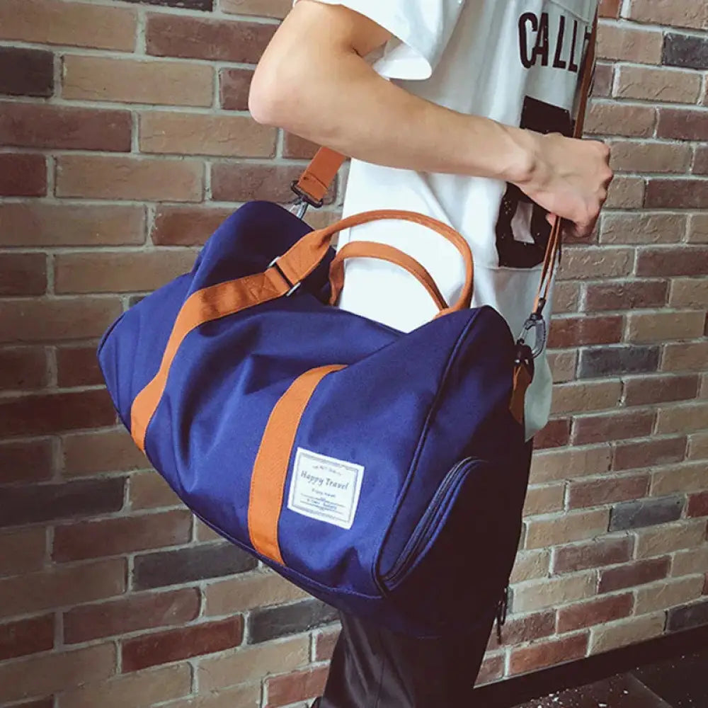 Navy blue and orange canvas women’s gym and weekend travel duffel bag with a white label patch
