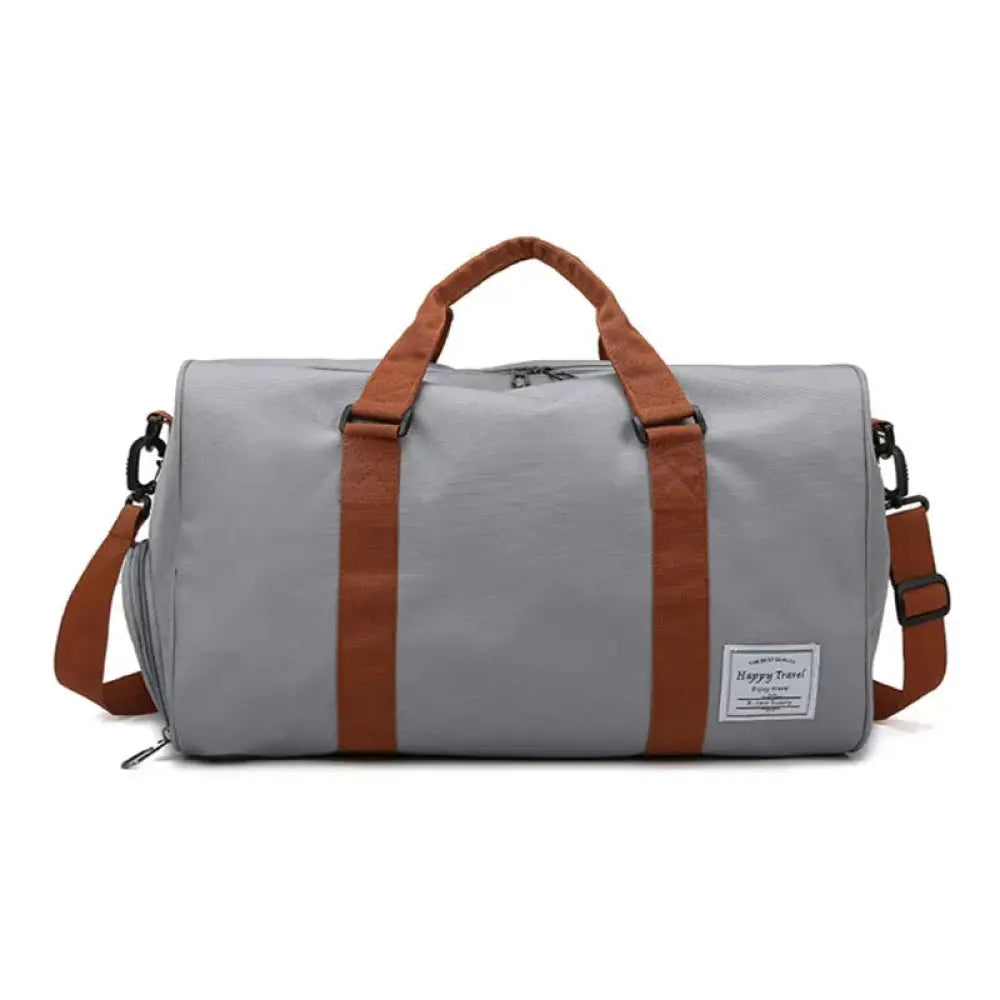 Women’s canvas gym and weekend travel duffel bag in gray and brown with sturdy fabric straps and front patch label