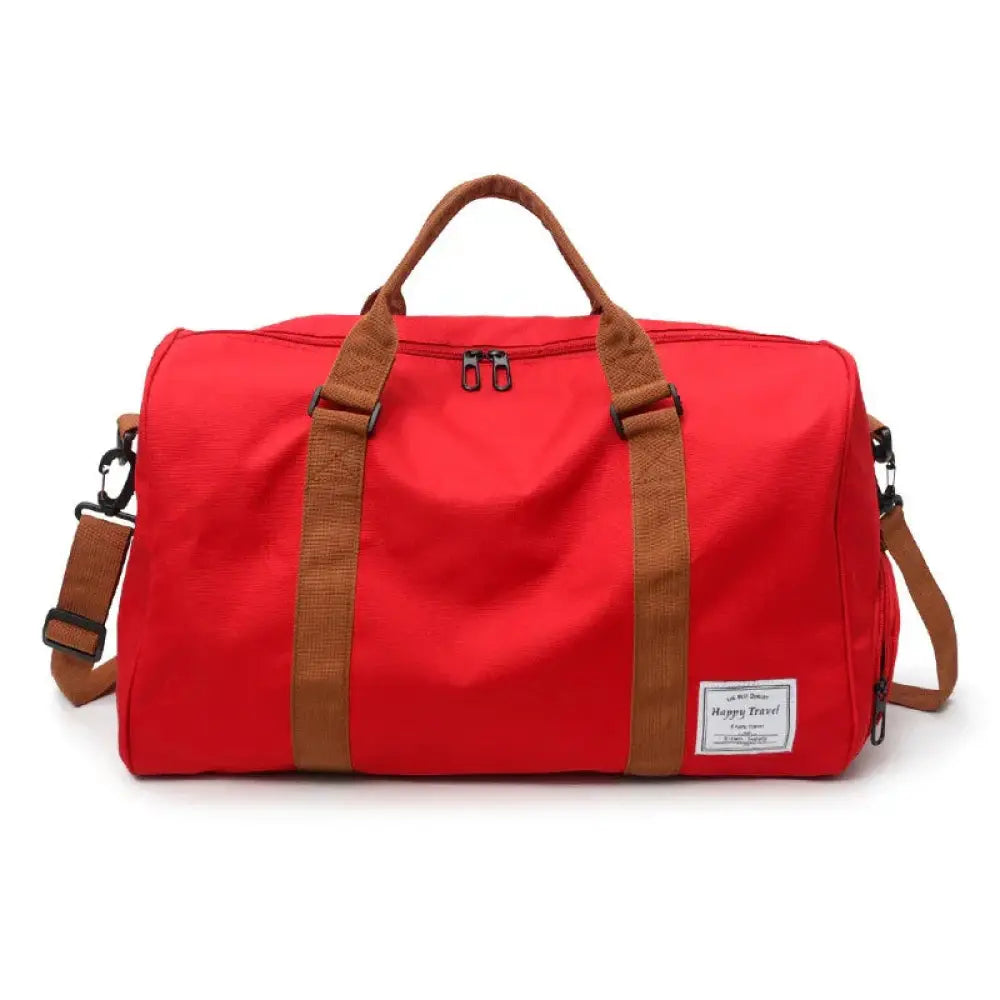 Red canvas gym and weekend travel duffel bag with brown webbing straps and happy travel label for women