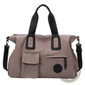 Beige nylon women travel duffel bag with black webbing handles and detachable shoulder strap large carry on tote