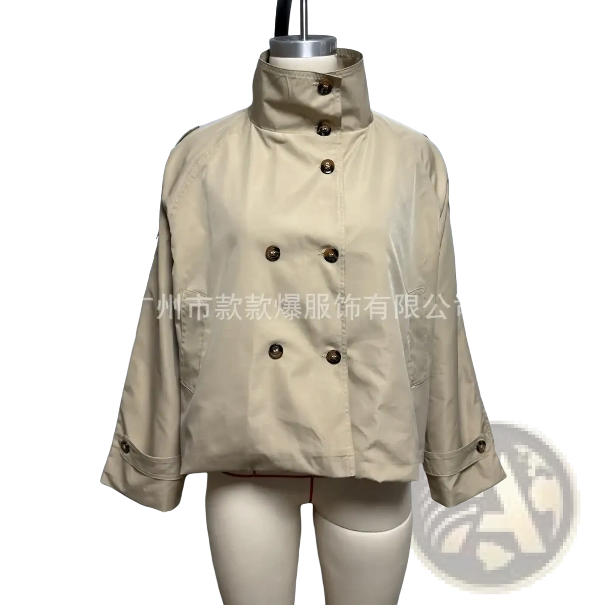 Beige double-breasted belted trench coat with dark brown buttons and rolled-up cuffs on mannequin for women