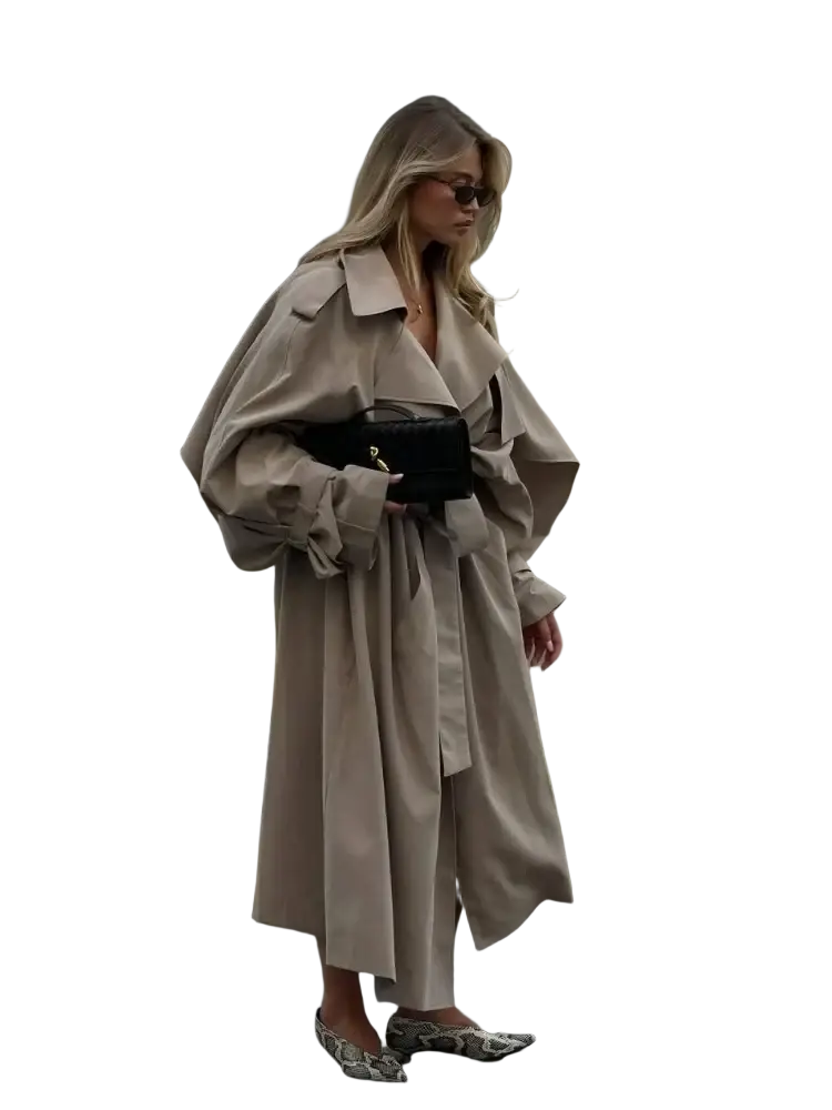 A black structured mini handbag with gold tone clasp and chain strap complementing women trench coat long casual outerwear black