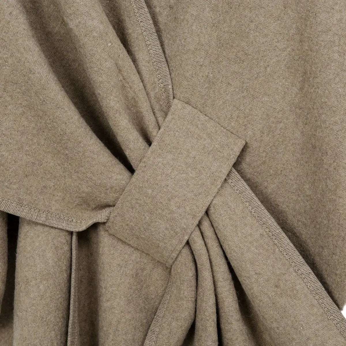 Women warm woolen poncho shawl cardigan in beige with a woolen coat texture and knotted belt detail