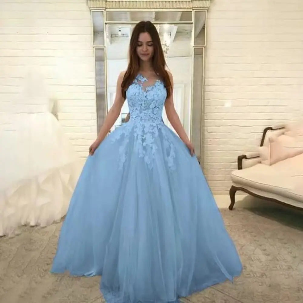 A light blue sleeveless wedding gown with intricate lace detailing and a flowing tulle floral skirt