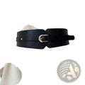 Women wide pu leather corset belt in black with a gold buckle cinching the waist of an off-white coat