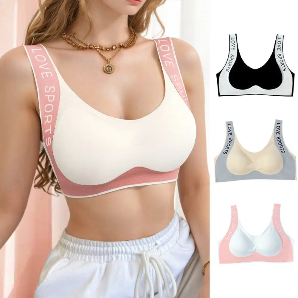Seamless cream-colored sports bra with pink trim and love sports lettering on wide straps for push up support