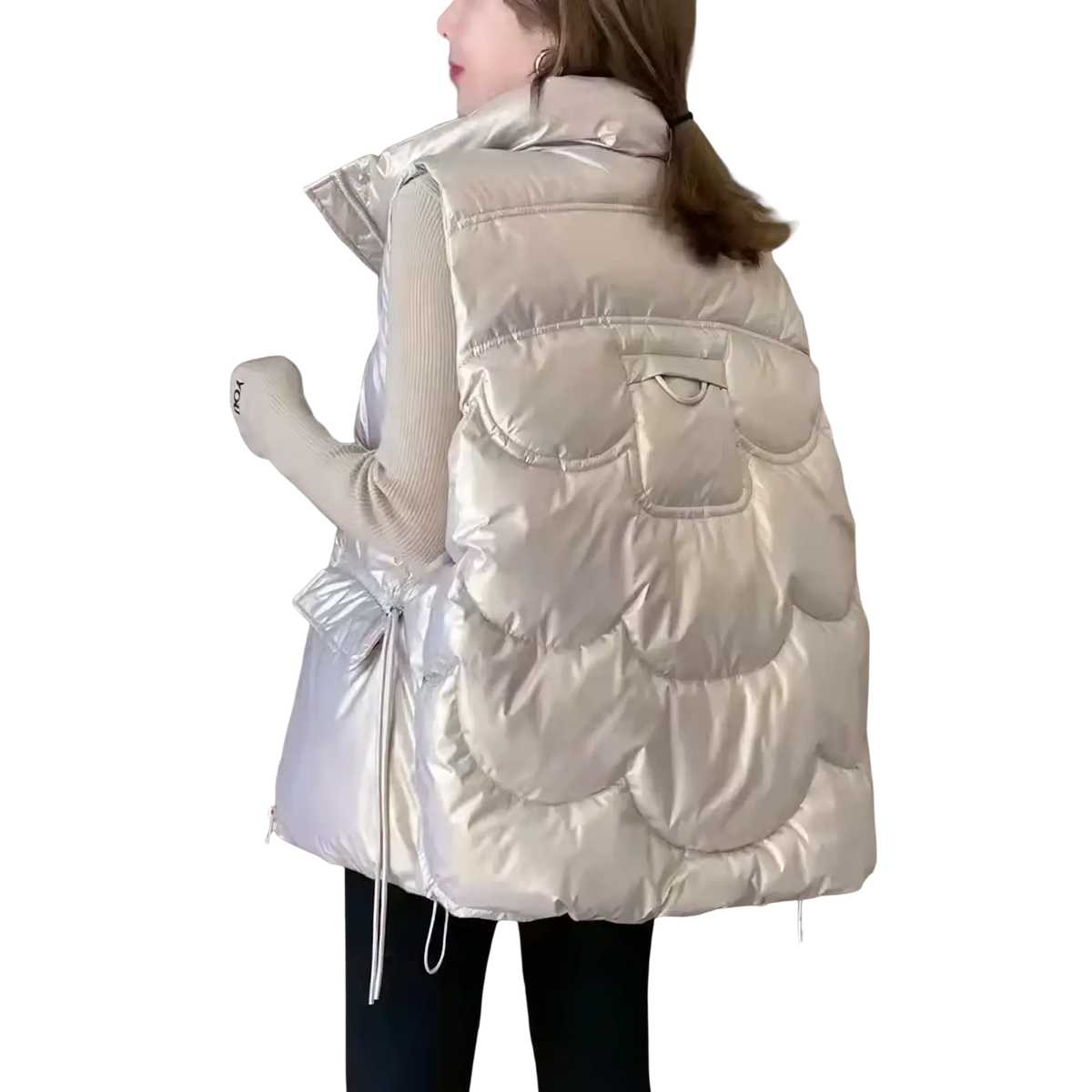 A shiny silver women winter hooded puffer vest with scalloped quilted design and a drawstring waist